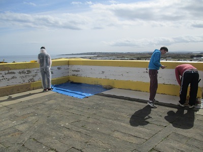 Students painting Covesea Lighthouse Lossiemouth